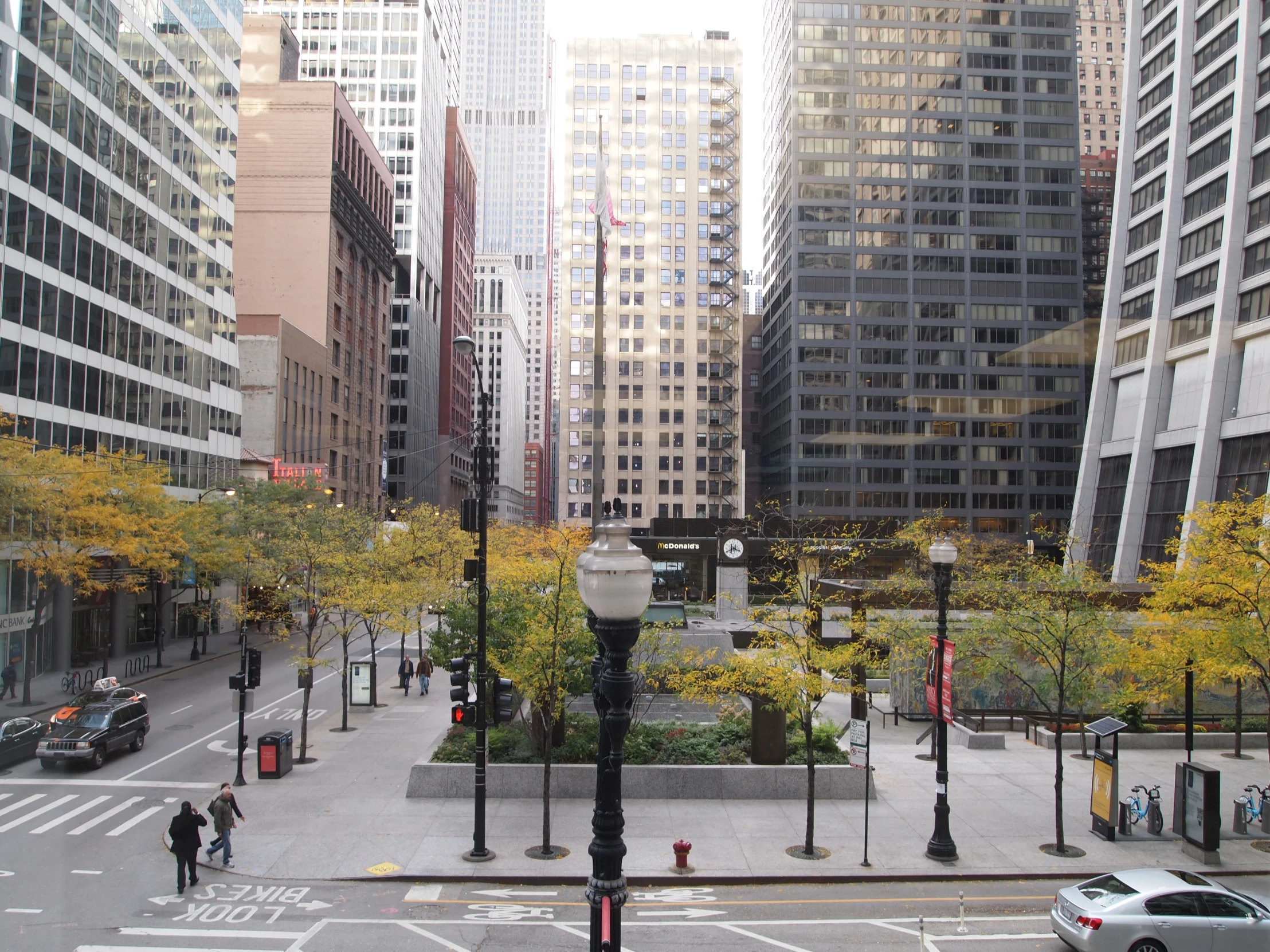 the street is busy with cars and pedestrians