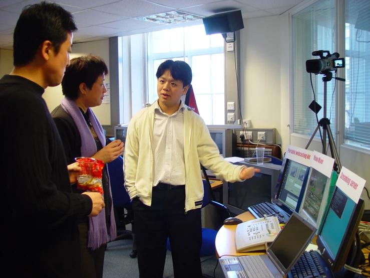 people standing near computers in a room