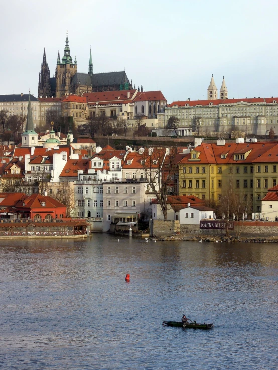 a boat floating in the middle of a river with buildings