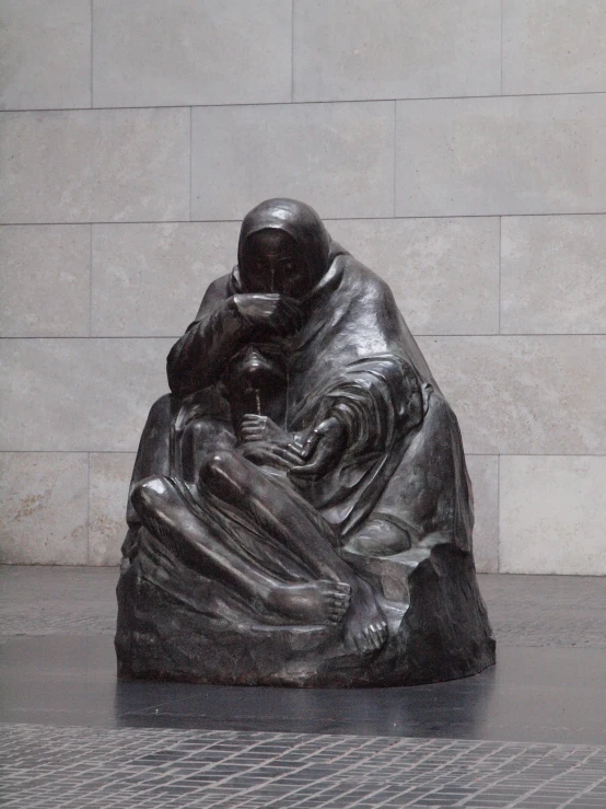 a statue of a man sitting on a stone bench
