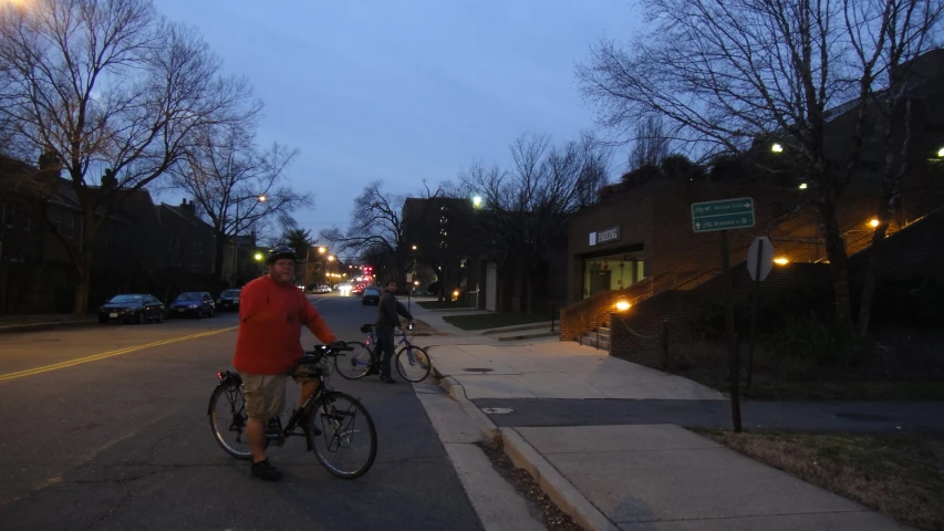 several people are riding bikes on a sidewalk