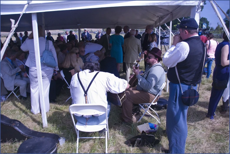 a group of people under a tent sitting down