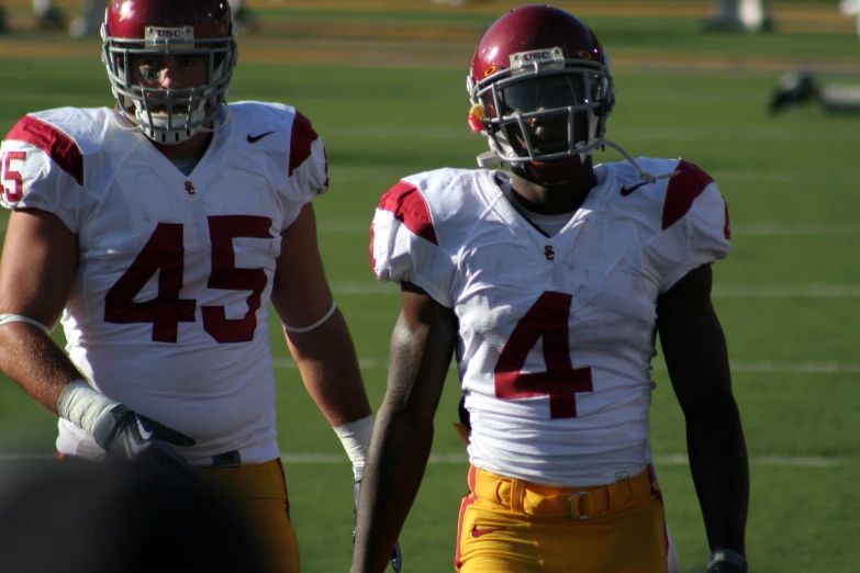 two football players are standing on the field together