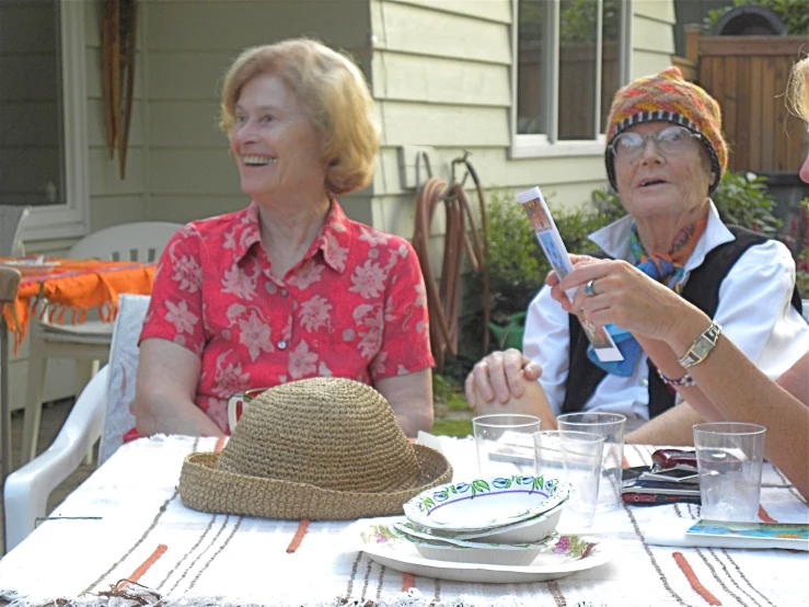 three women are sitting down on the table