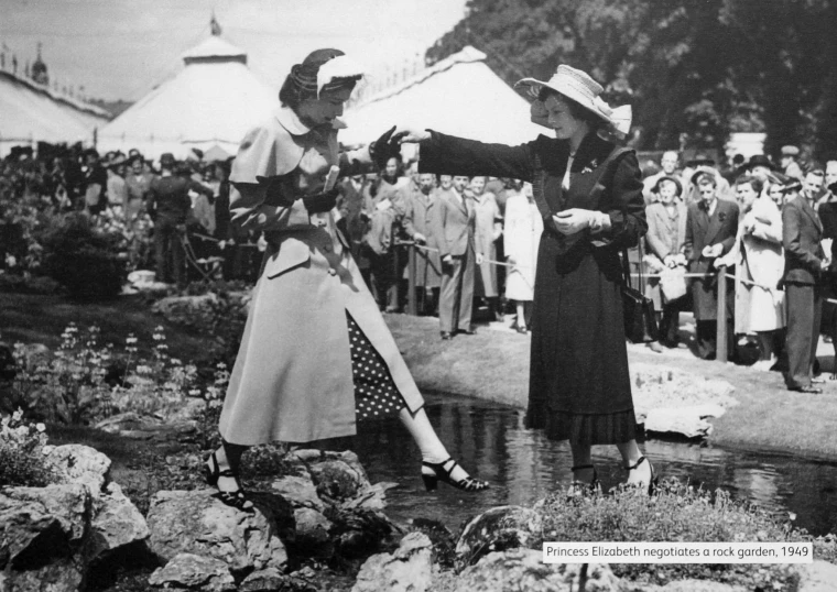 two ladies standing in front of a crowd of people