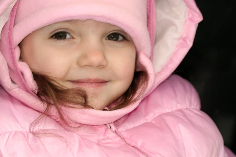 a  in a pink coat is posing