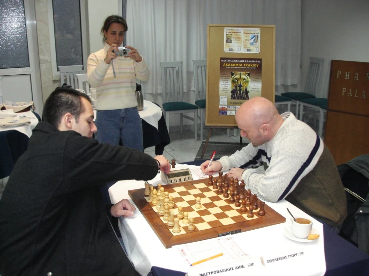 a man is being played chess with a woman