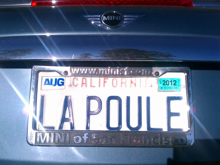 an la paouie license plate sits in the back of a blue car