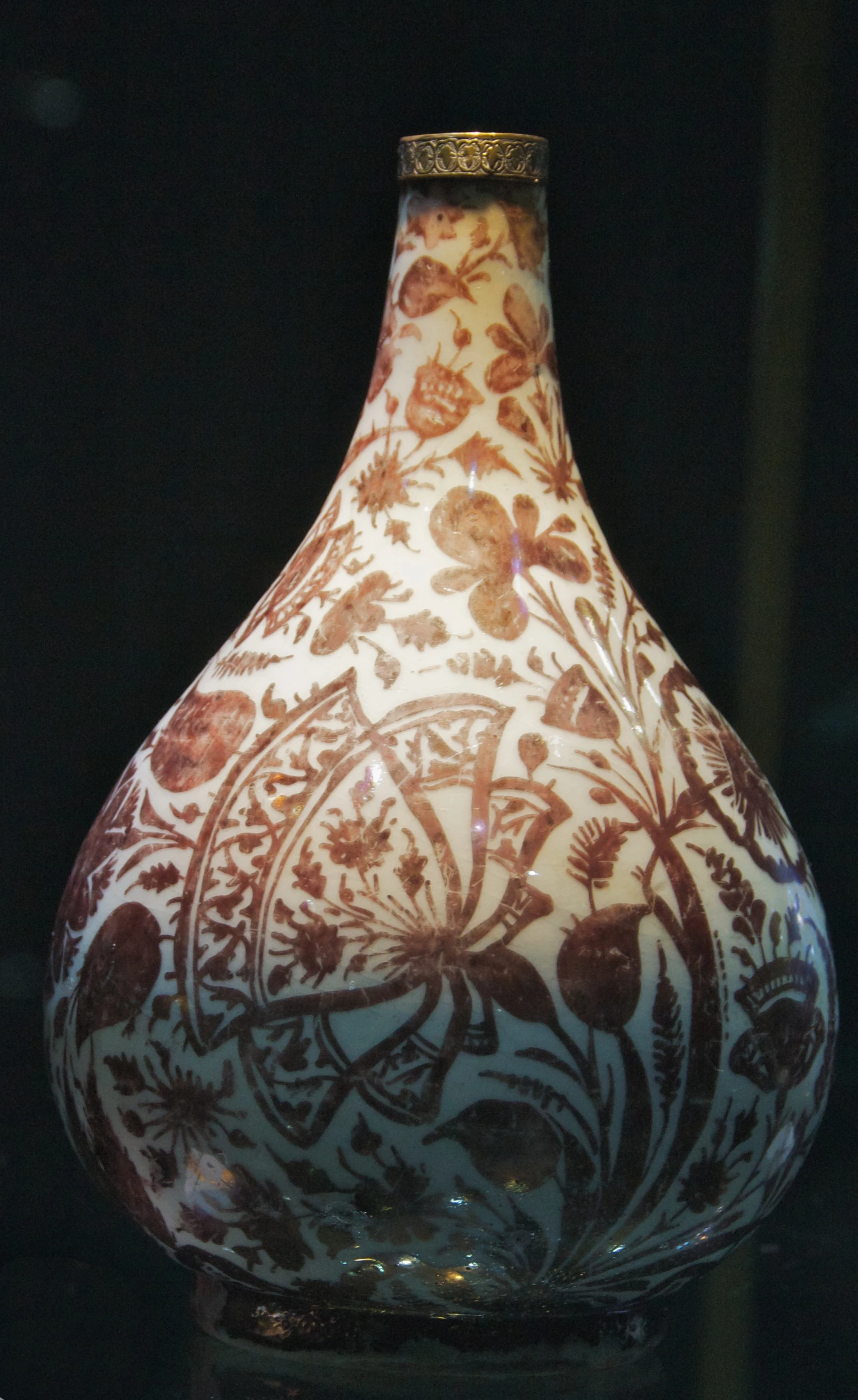 a red and white vase with a design on it