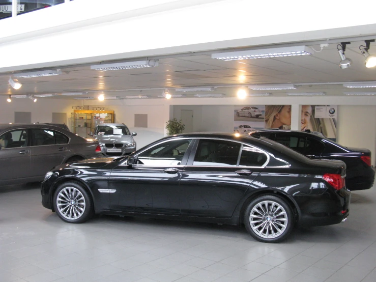 black cars parked inside a building and some buildings