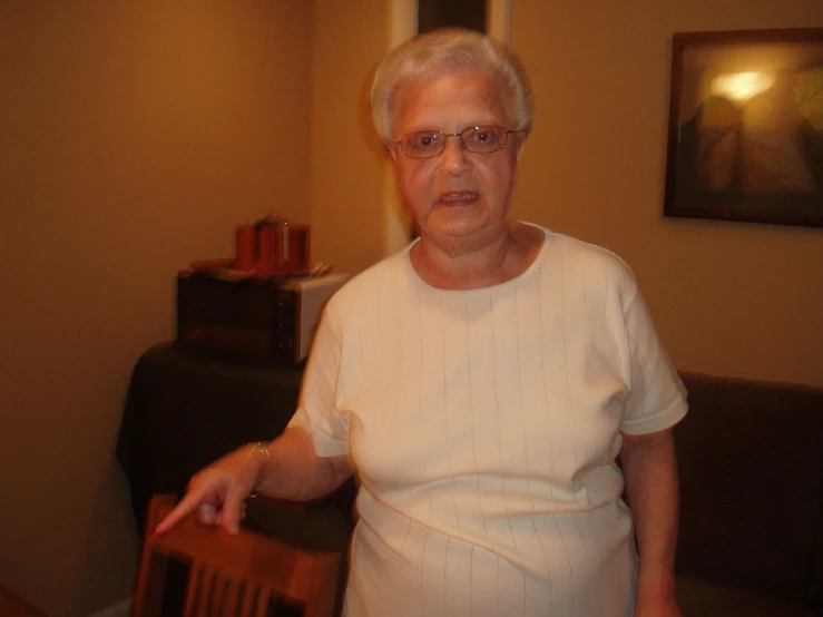 an old lady sitting at a table in her living room