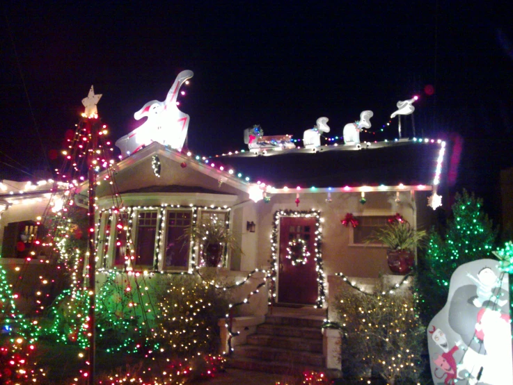 a house decorated in christmas lights and decorations