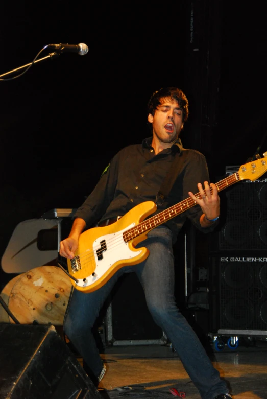 a young man with a white electric guitar