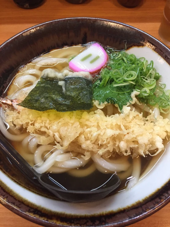 an image of a plate of noodles with chopsticks