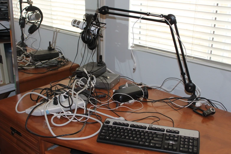 a desk with several computer and keyboards all over it