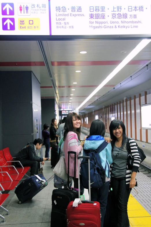four women with luggage and waiting for the baggage at the airport