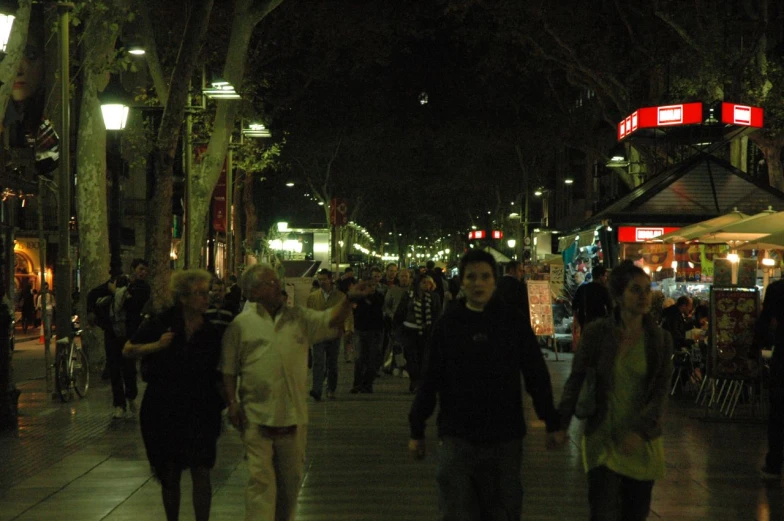 many people are walking down a busy street