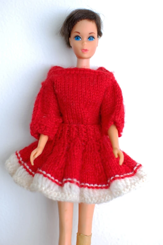 a red and white doll on a white background
