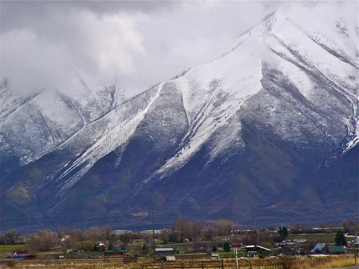 the mountains are covered in snow and clouds