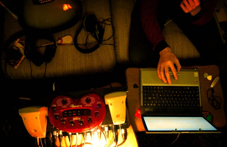 person typing on a laptop in the dark