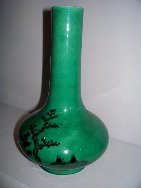 this is a close up image of a green vase