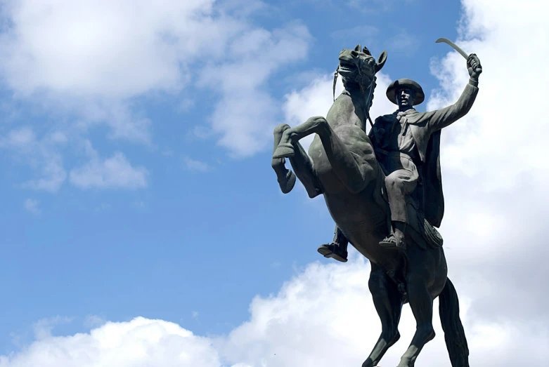 a statue of a man riding a horse that has a man on it