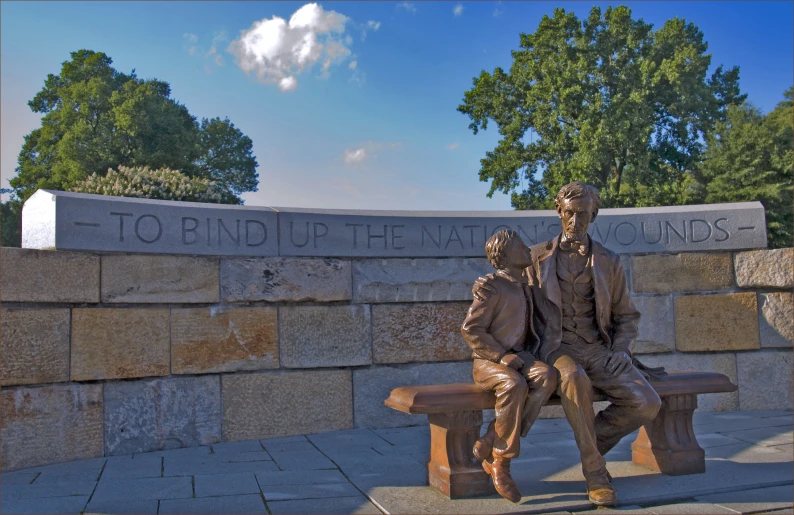 a monument on a side walk in front of the town