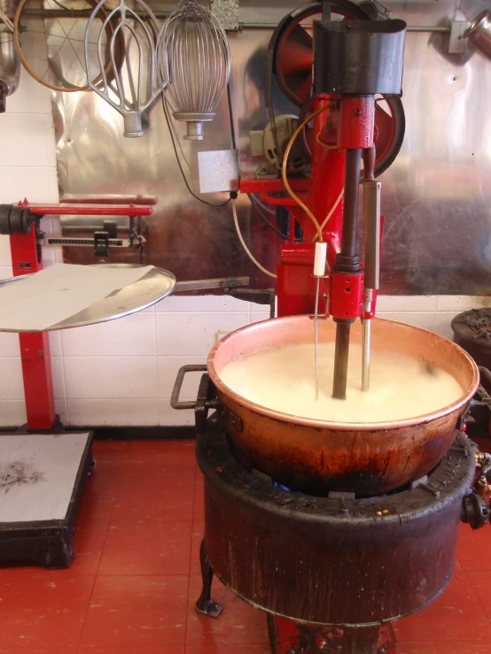 an industrial machinery machine is moving a bowl