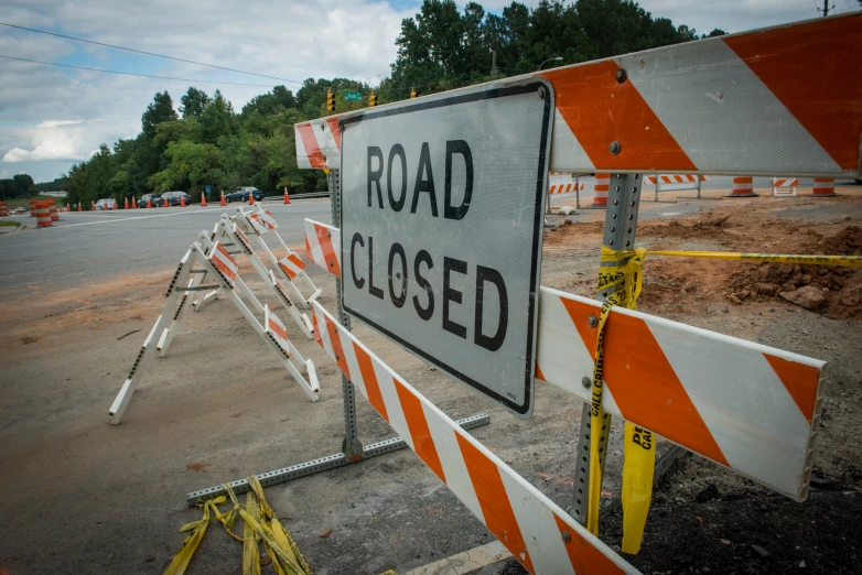 road closed sign blocking roadway near construction area