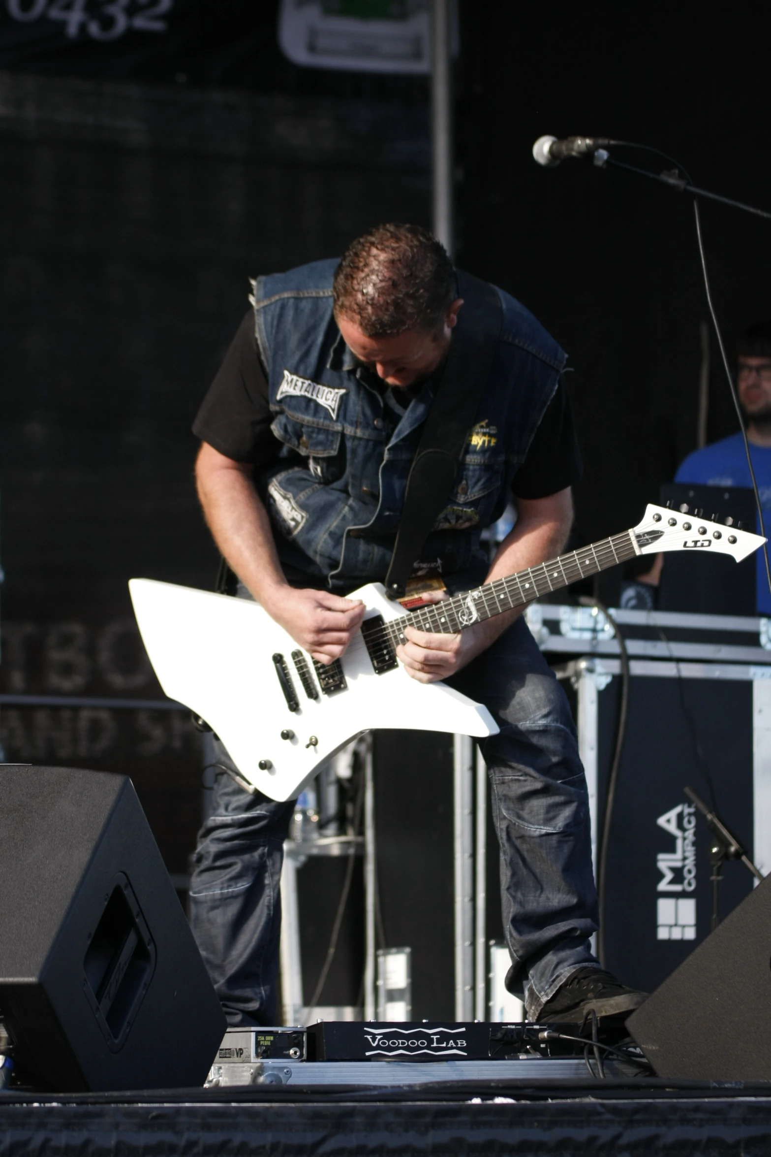 a man playing an electric guitar on stage