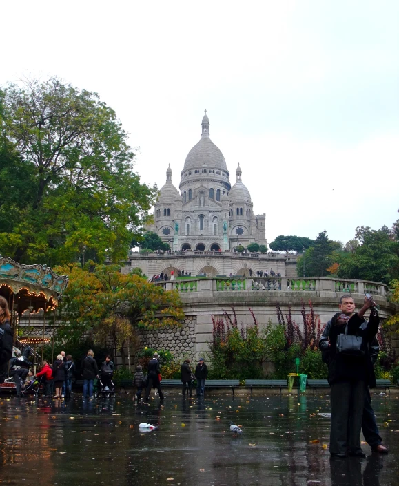 a group of people are standing in the rain