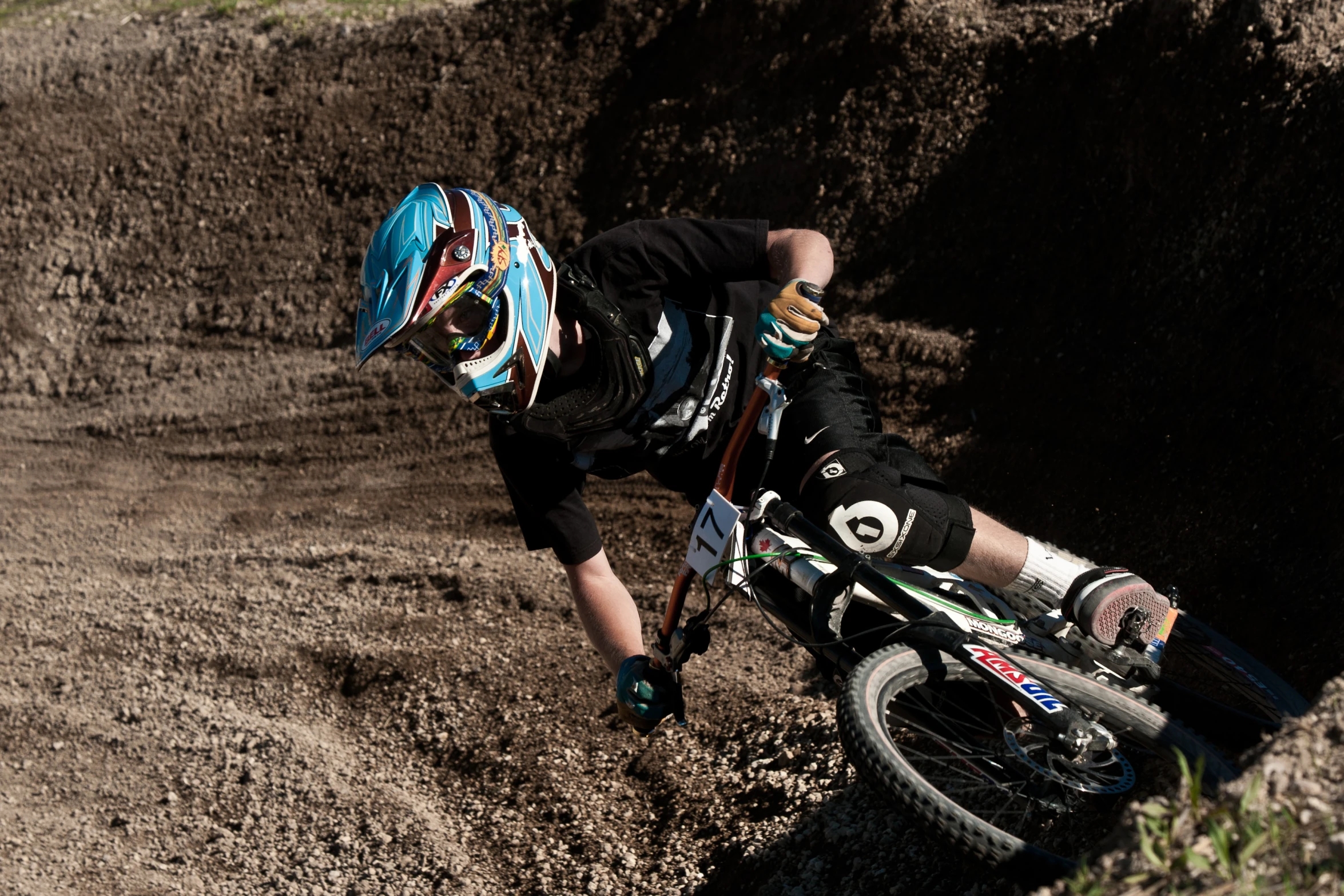 a man on a dirt bike rides through some mud