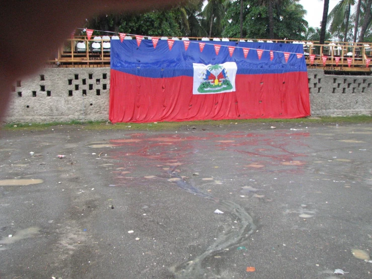a large blue and red banner with a coat over it