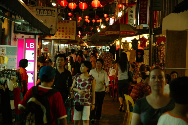 the busy street has many people and shops