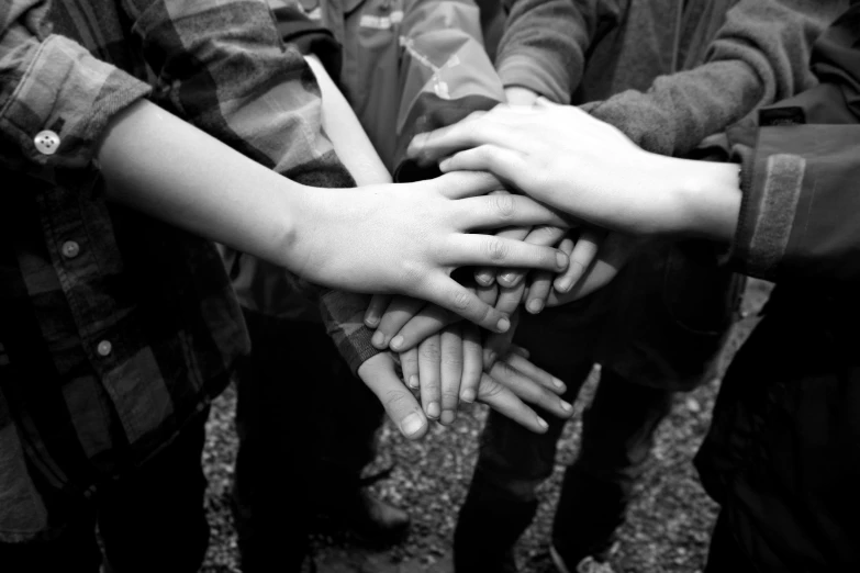 a group of hands holding each other in the middle