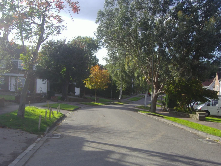 the street has cars and a bus in it