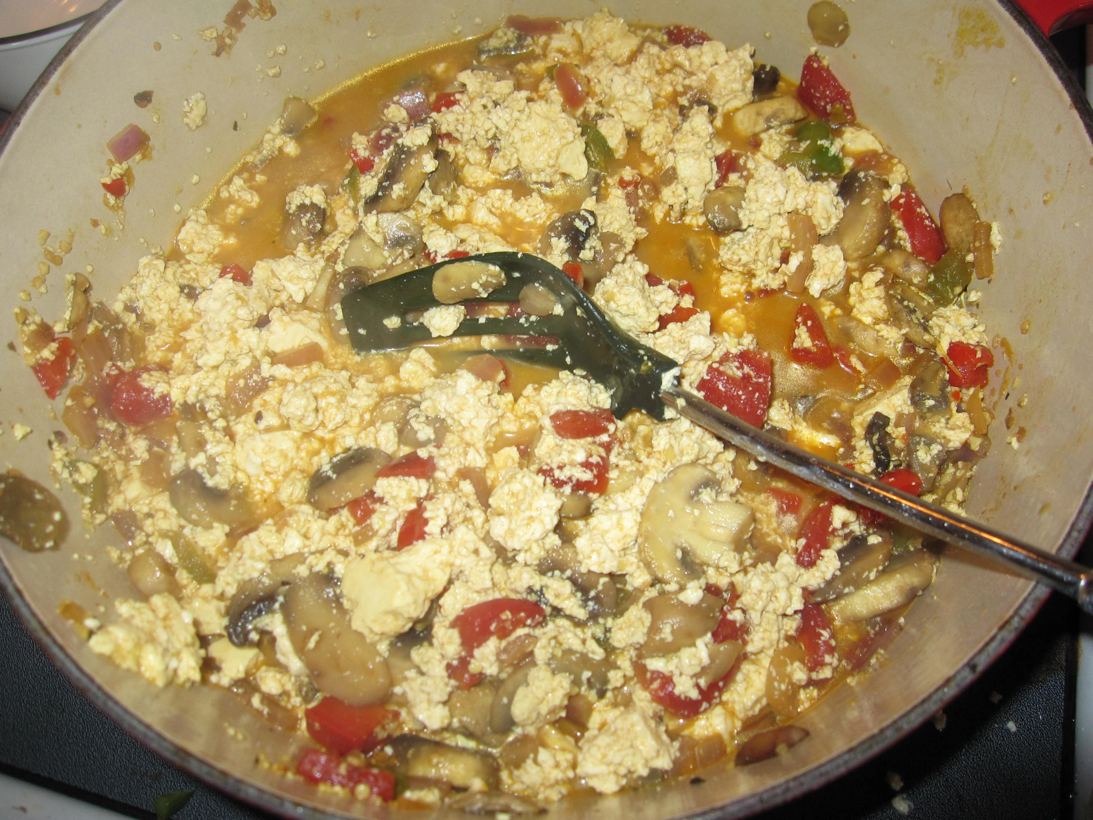 a frying pan filled with cooked vegetables and egg