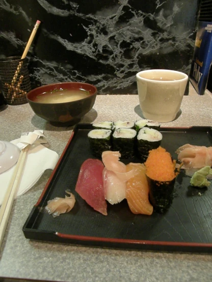 a dish with chopsticks and sushi on it
