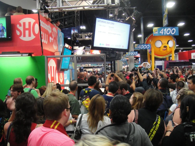 a crowd in an indoor store looking at displays