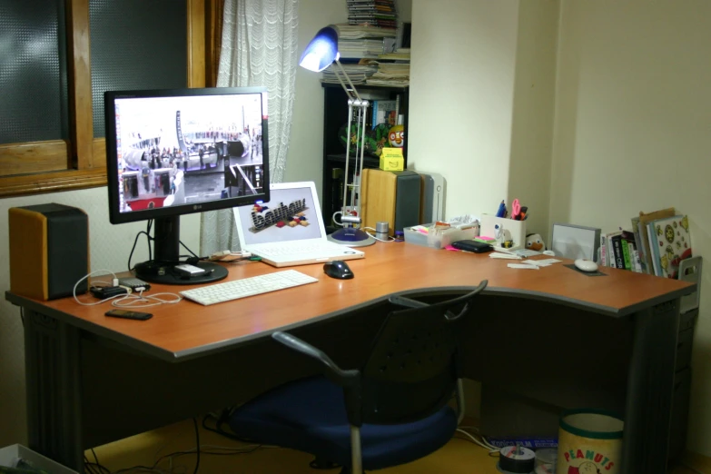 computer with laptop on desk in messy office