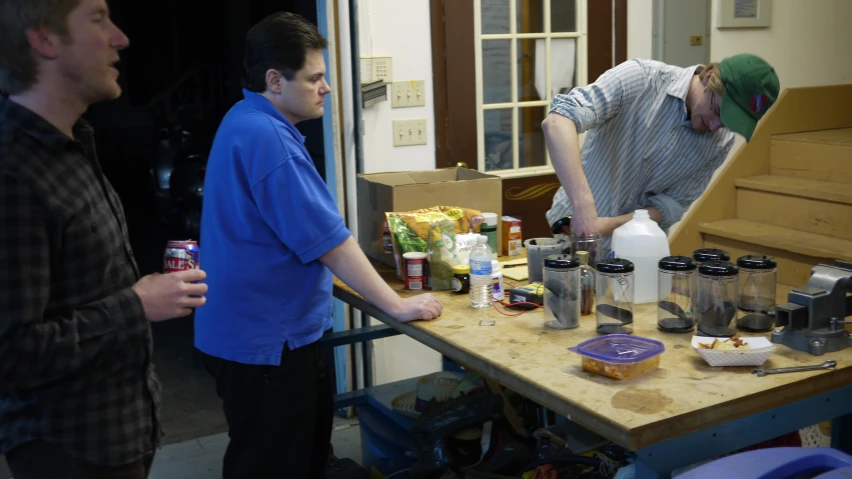 two men look at various items on a table