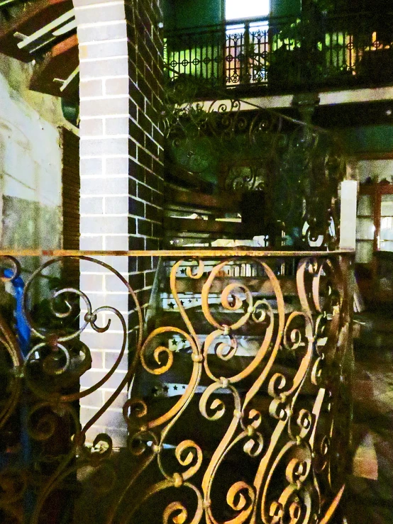 ornate iron railing with balcony balconies and stairway in urban setting