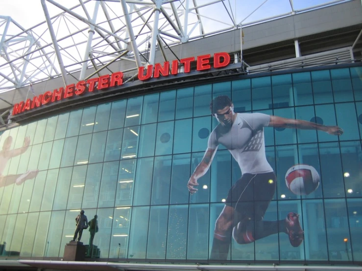 a man in black shorts standing in front of a large building