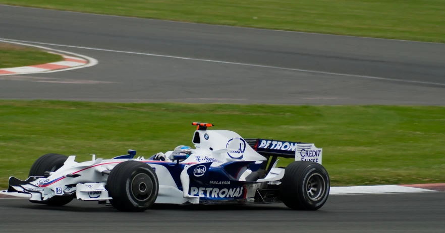 the driver of a racing car rounding a corner on the track