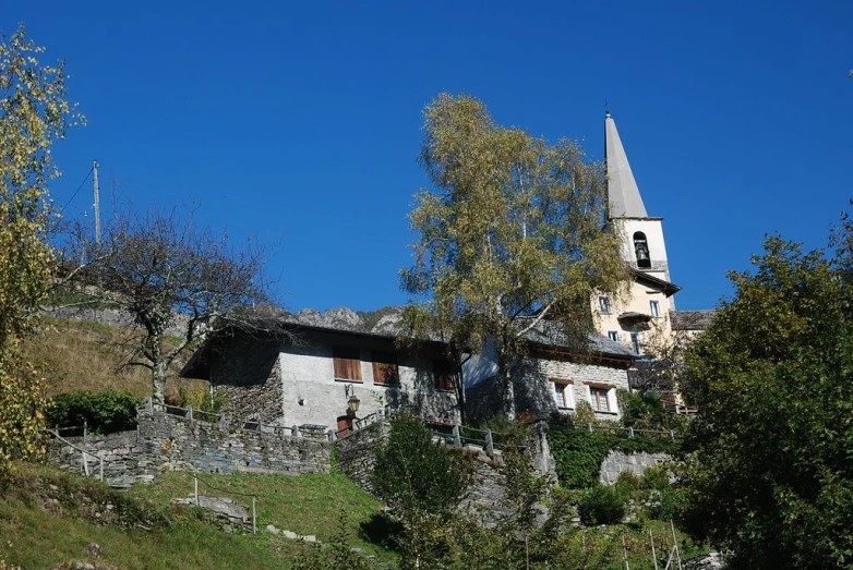 a house in the woods with an old church in the background