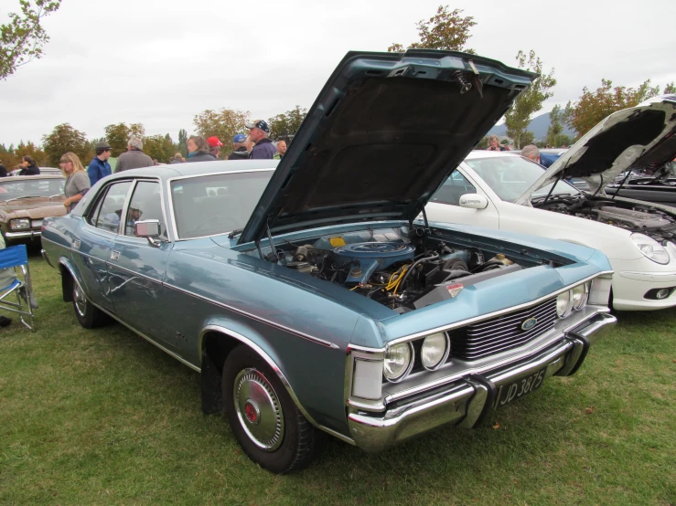 a vintage car is on display at the event