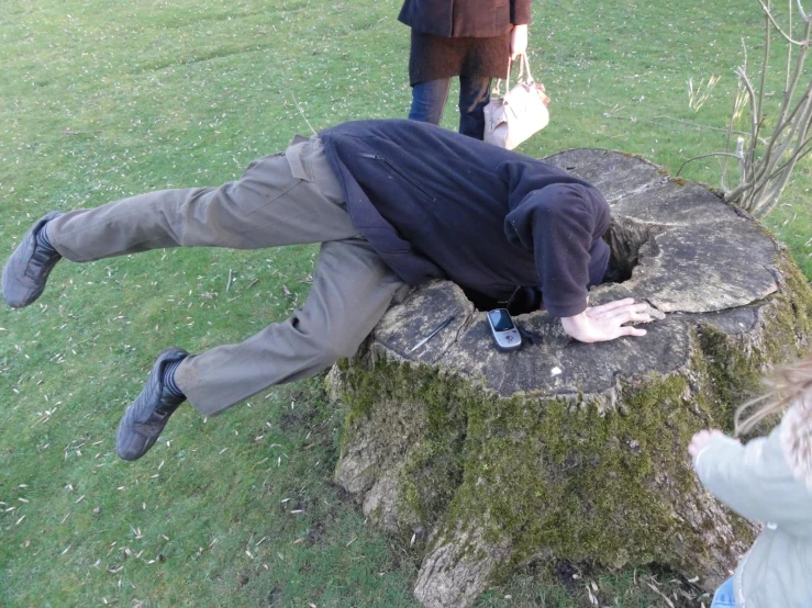 a person is laying down on a large piece of wood