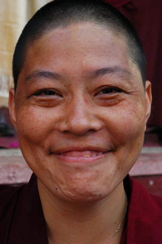 a person wearing a red jacket smiling for the camera