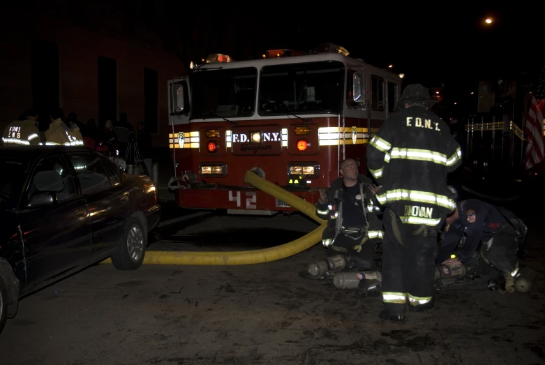 firemen and police work to put out a house fire