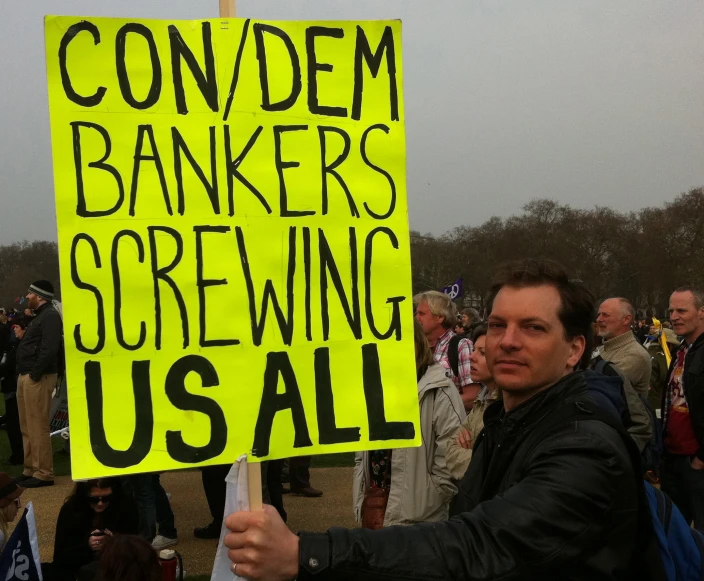 there is a man holding a sign at an event